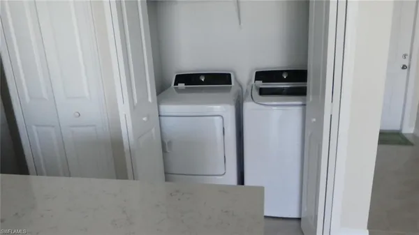 a view of walk in closet with clothes
