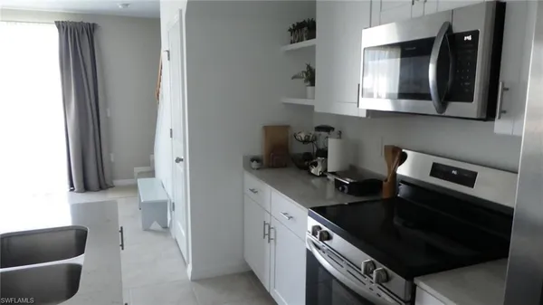 a kitchen with a stove and a white cabinet