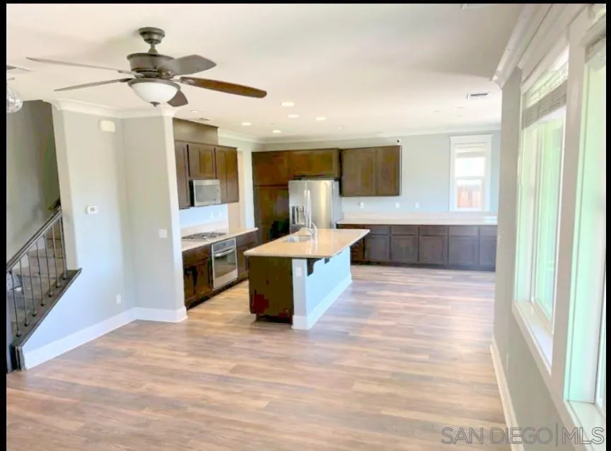5311 Gramercy Circle Fairfield, CA 94533 - Photo 12 of 54 a view of living room kitchen with stainless steel appliances wooden floor and window