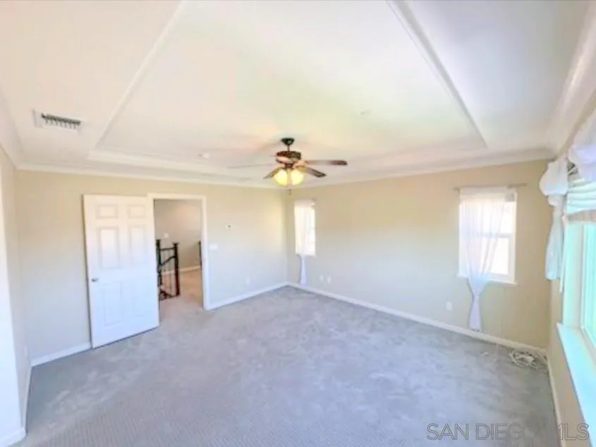 5311 Gramercy Circle Fairfield, CA 94533 - Photo 17 of 54 an empty room with windows and chandelier fan