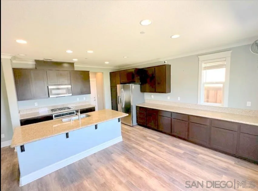 5311 Gramercy Circle Fairfield, CA 94533 - Photo 26 of 54 a large kitchen with stainless steel appliances a large counter top a stove and a sink