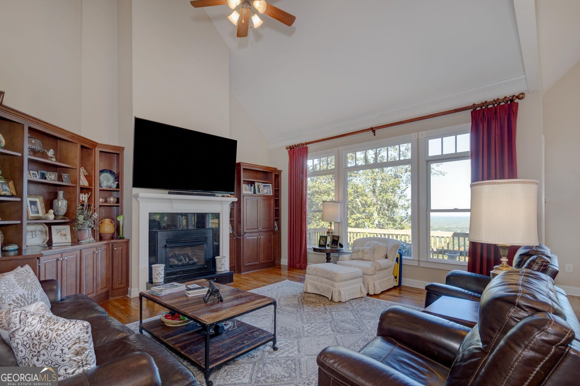 551 Mountain Ridge Drive Manchester, GA 31816 - Photo 11 of 72 This room showcases fireplace with gas logs with built in shelving on both sides.