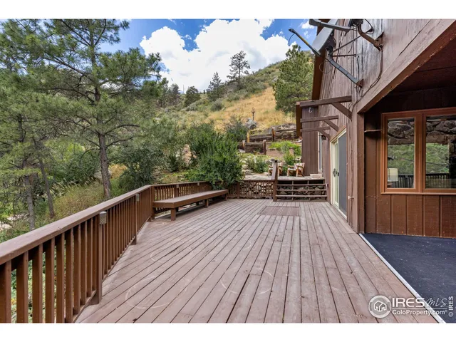 a view of balcony with wooden floor and outdoor seating