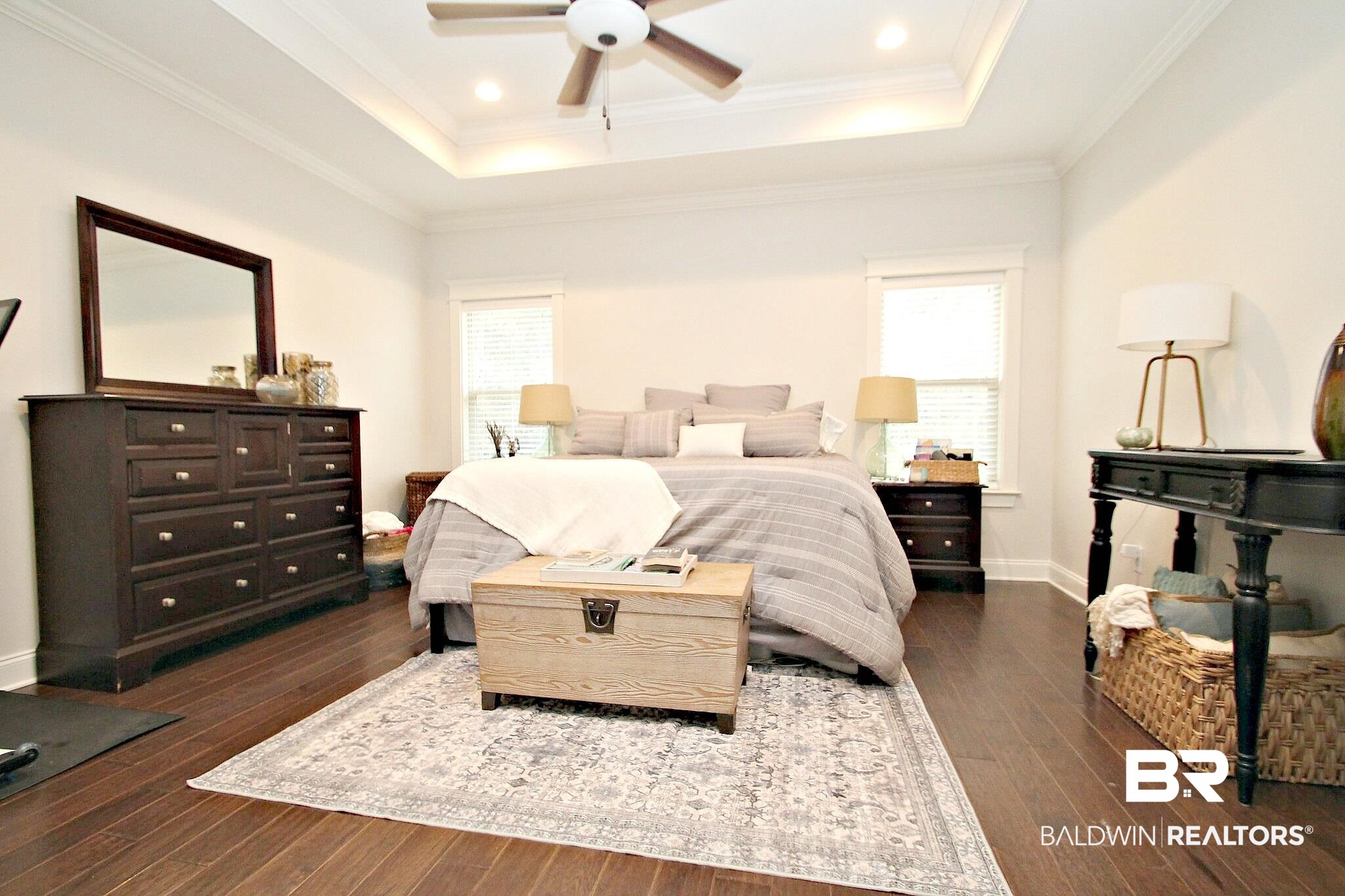 30232 Persimmon Drive Daphne, AL 36527 - Photo 12 of 27 Bedroom featuring dark wood-type flooring, a tray ceiling, and multiple windows