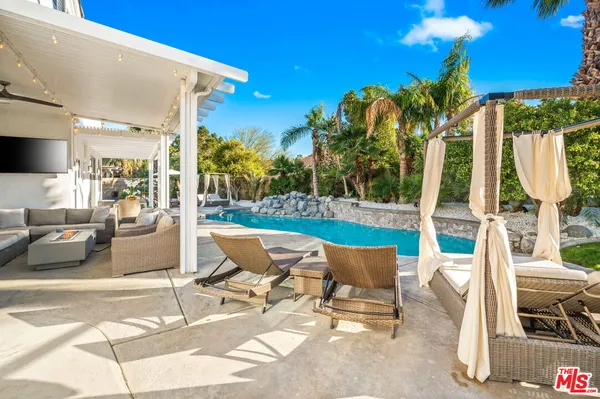 a building outdoor space with patio furniture and potted plants