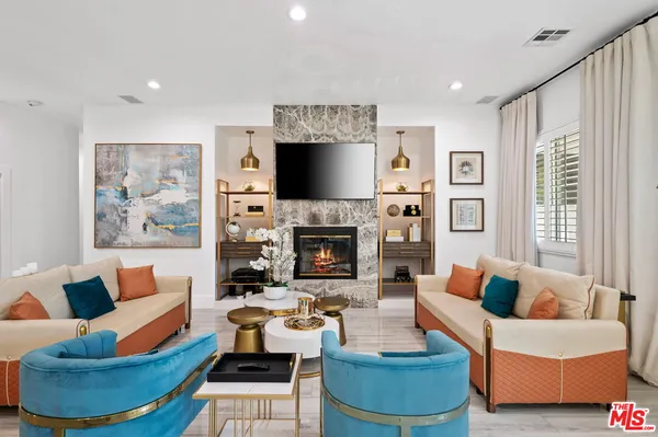 a living room with fireplace furniture and a flat screen tv