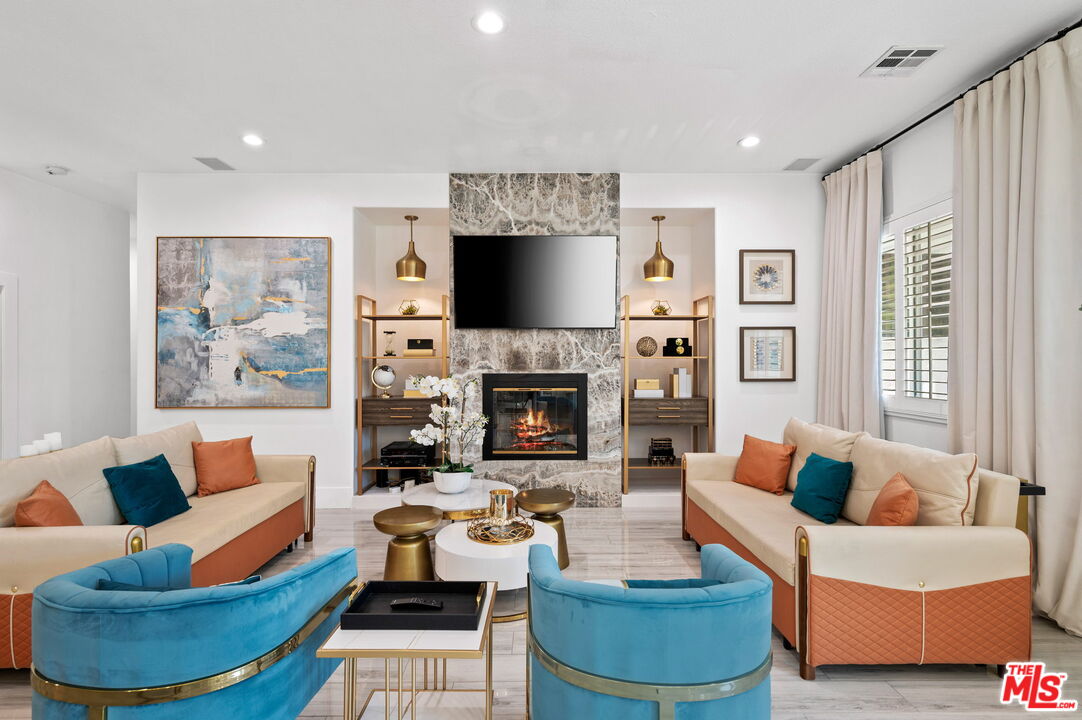 1083 East Circulo San Sorrento Road Palm Springs, CA 92262 - Photo 11 of 70 a living room with furniture a flat screen tv and a fireplace