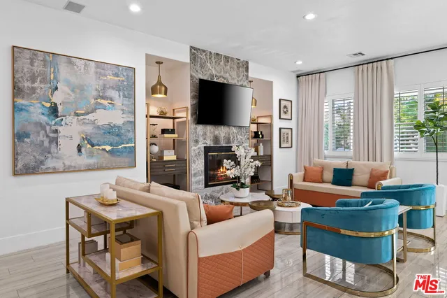 a kitchen with stainless steel appliances granite countertop a stove a sink dishwasher and a refrigerator with wooden floor