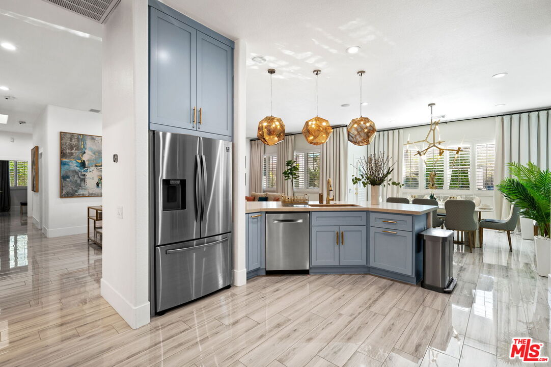 1083 East Circulo San Sorrento Road Palm Springs, CA 92262 - Photo 15 of 70 a kitchen with sink refrigerator and cabinets