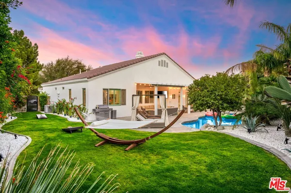 a view of a house with backyard and a slide