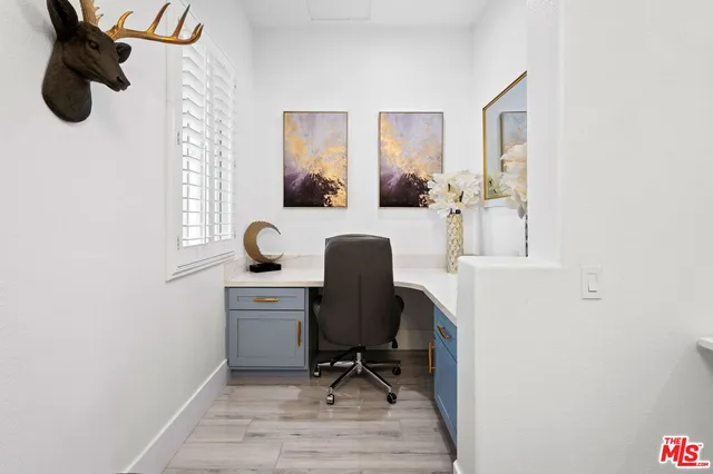 a living room with furniture and a lamp