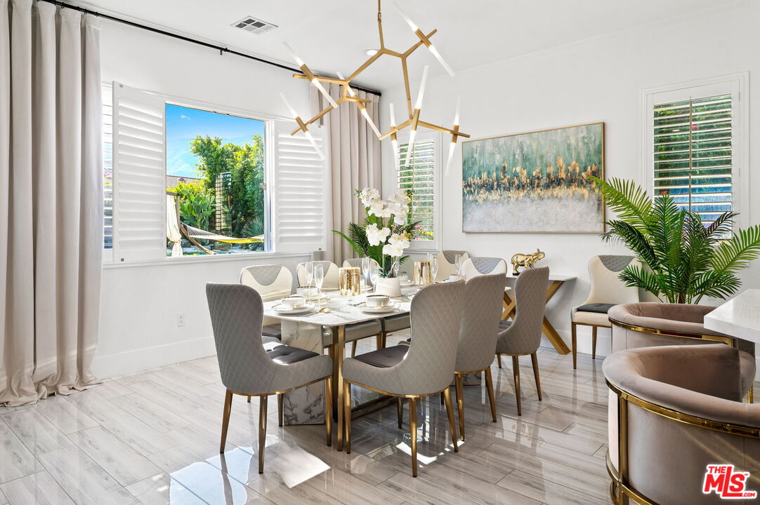 1083 East Circulo San Sorrento Road Palm Springs, CA 92262 - Photo 25 of 70 a view of a dining room with furniture window and wooden floor