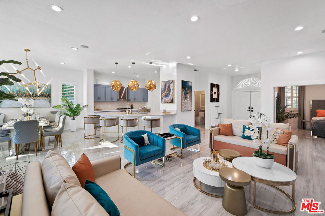 1083 East Circulo San Sorrento Road Palm Springs, CA 92262 - Photo 28 of 70 a living room with furniture a rug kitchen view and a table