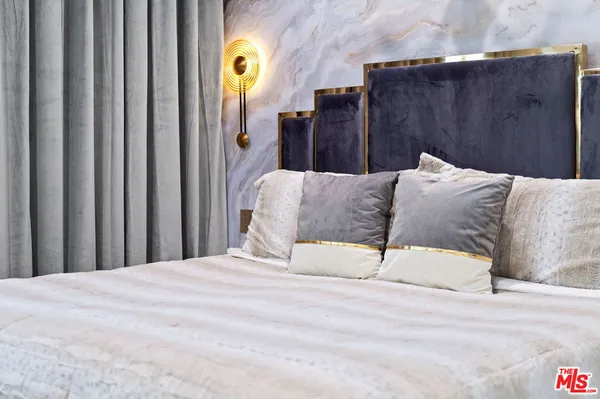 a bedroom with furniture and a flat screen tv