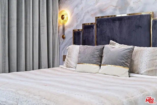 a bedroom with furniture and a flat screen tv