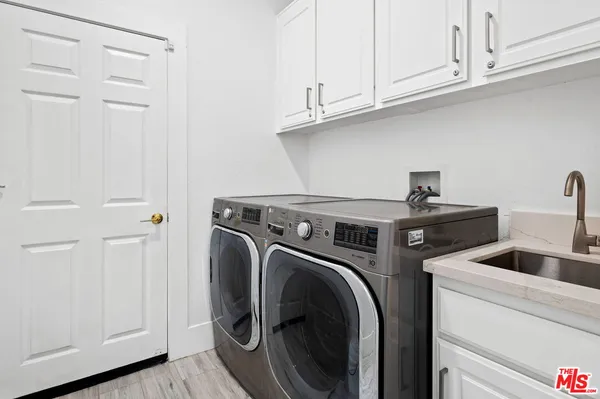 a view of a table and chairs in a backyard