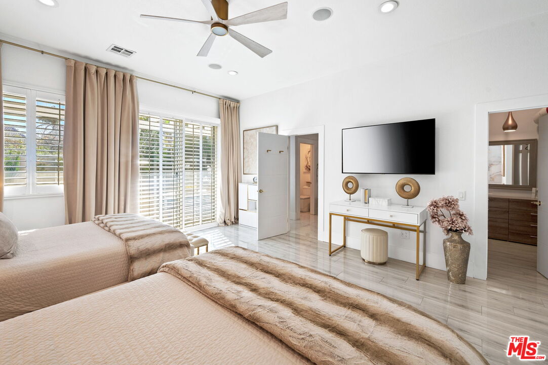 1083 East Circulo San Sorrento Road Palm Springs, CA 92262 - Photo 45 of 70 a bedroom with furniture and a flat screen tv