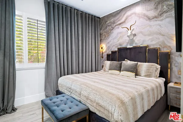 a room with furniture pool table and painting on the wall