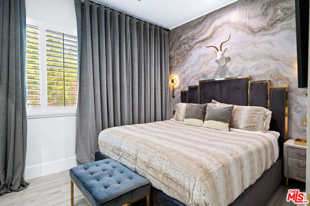 1083 East Circulo San Sorrento Road Palm Springs, CA 92262 - Photo 5 of 70 a bedroom with a bed and wooden floor