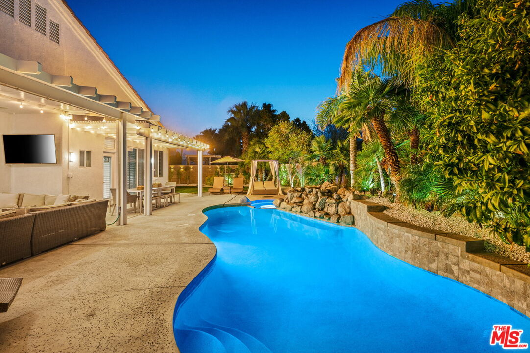 1083 East Circulo San Sorrento Road Palm Springs, CA 92262 - Photo 70 of 70 a view of a swimming pool with an outdoor seating and a yard