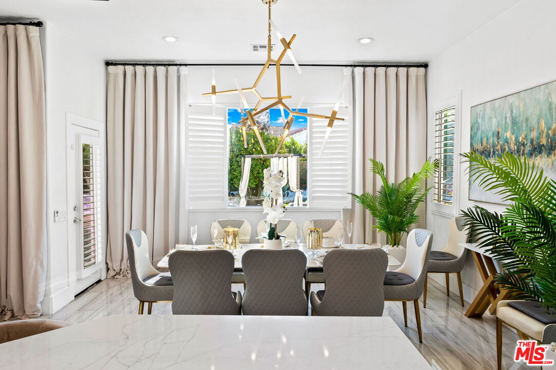 1083 East Circulo San Sorrento Road Palm Springs, CA 92262 - Photo 9 of 70 a dining room with furniture and a potted plant