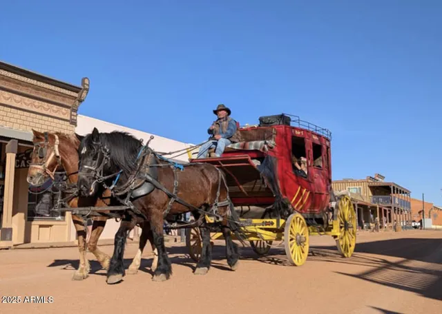 a view of gym equipment and a car parked beside a road