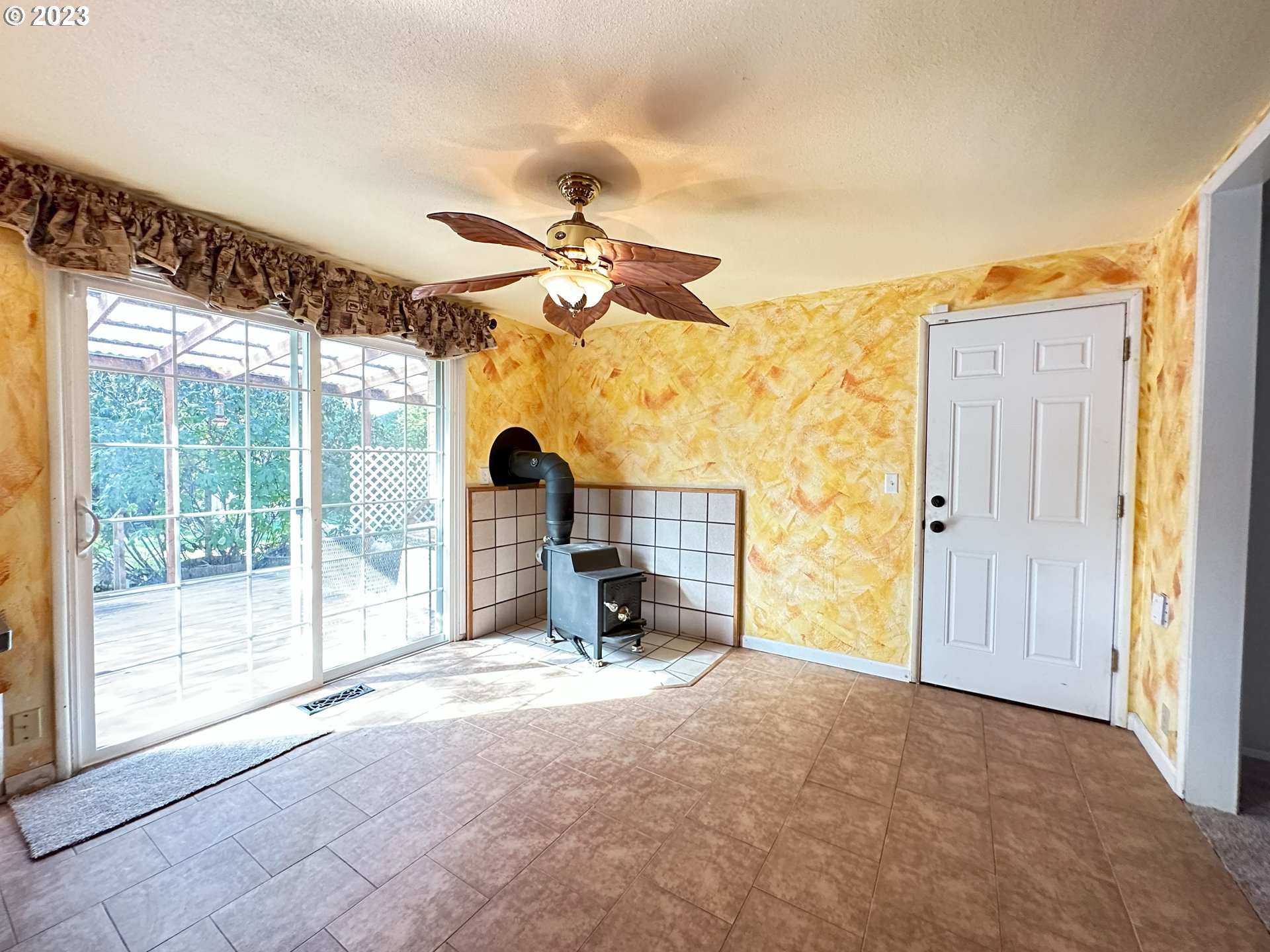 2496 Debra Drive Springfield, OR 97477 - Photo 17 of 43 a view of a livingroom with a fireplace and a ceiling fan