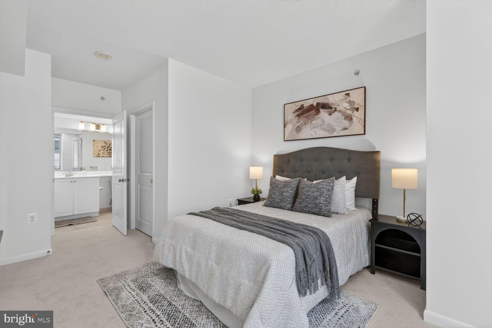 851 North Glebe Road, Unit 817 Arlington, VA 22203 - Photo 11 of 29 a bedroom with a bed and a view of bathroom