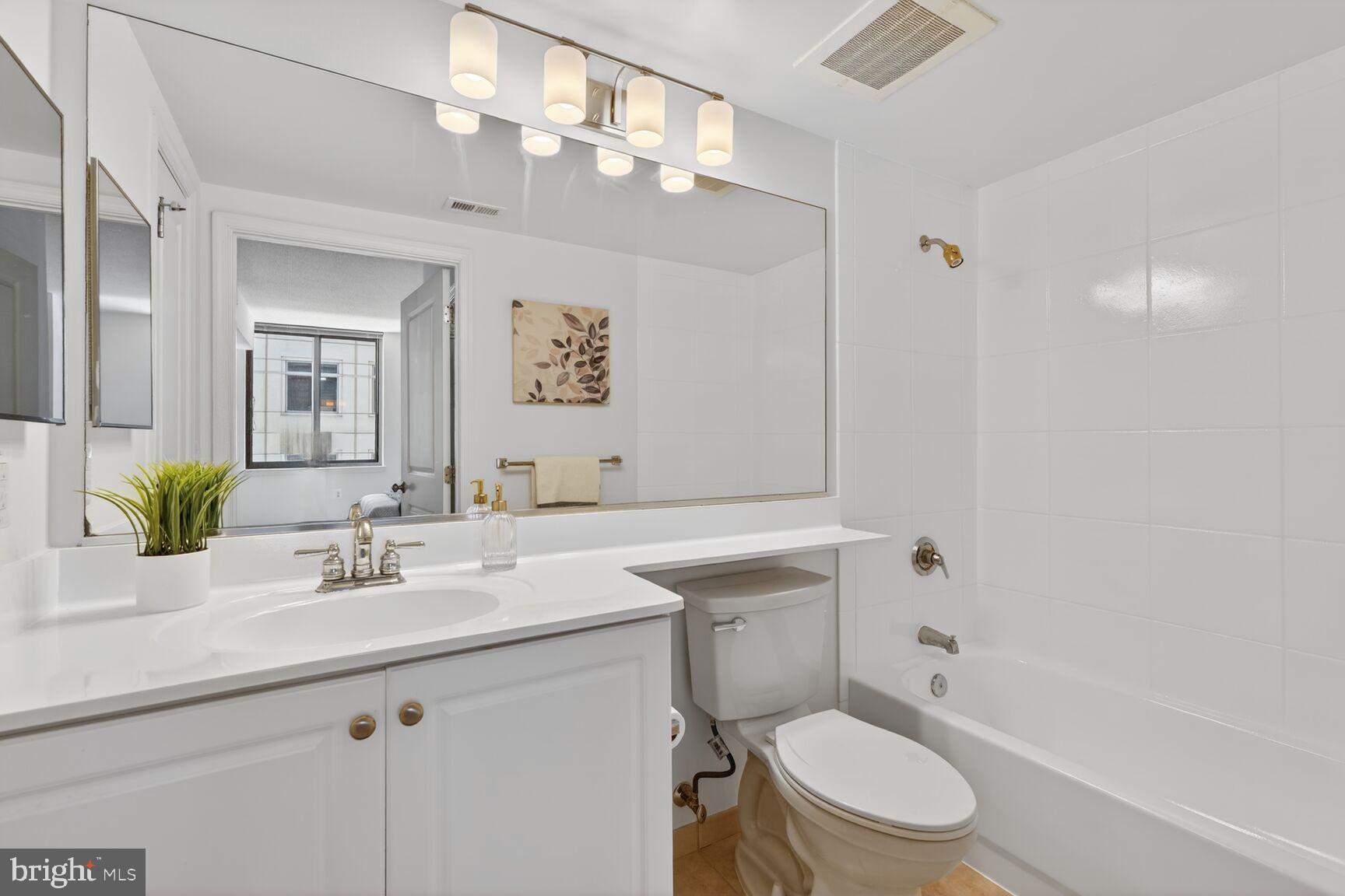 851 North Glebe Road, Unit 817 Arlington, VA 22203 - Photo 13 of 29 a bathroom with a sink a toilet and shower