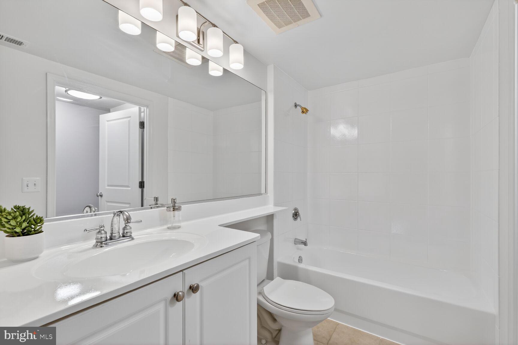 851 North Glebe Road, Unit 817 Arlington, VA 22203 - Photo 17 of 29 a bathroom with a sink a toilet and shower