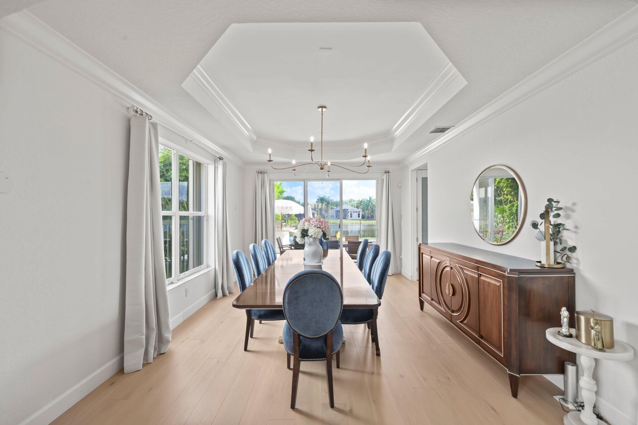 19650 Estuary Drive Boca Raton, FL 33498 - Photo 12 of 83 a living room with furniture a chandelier and a large window