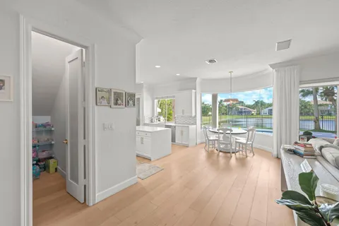 a dining room with furniture a chandelier and wooden floor