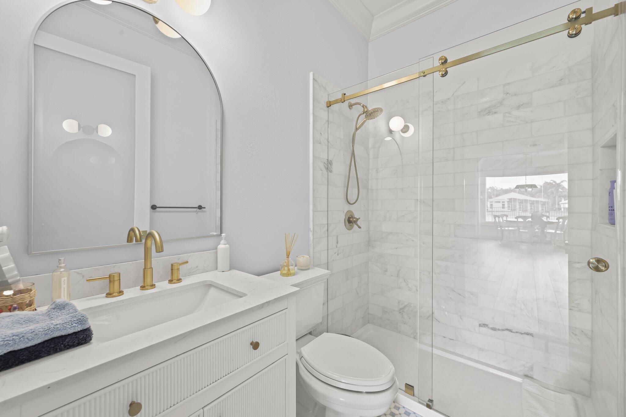 19650 Estuary Drive Boca Raton, FL 33498 - Photo 17 of 83 a bathroom with a sink a toilet and shower