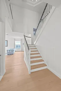 a kitchen with stainless steel appliances a stove top oven a sink a refrigerator and white cabinets