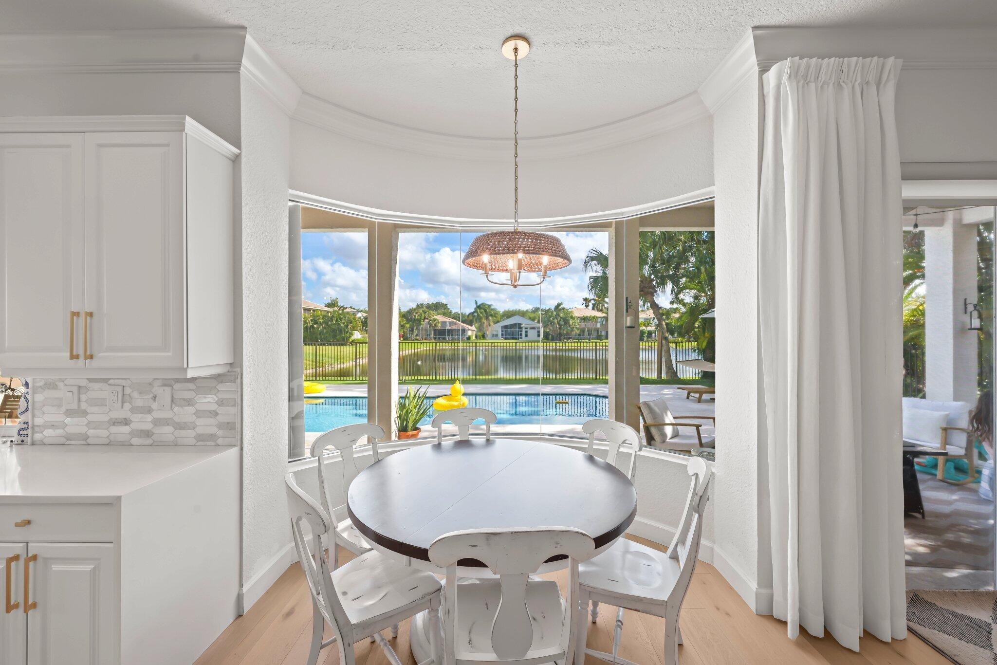19650 Estuary Drive Boca Raton, FL 33498 - Photo 21 of 83 a dining room with furniture a chandelier and wooden floor