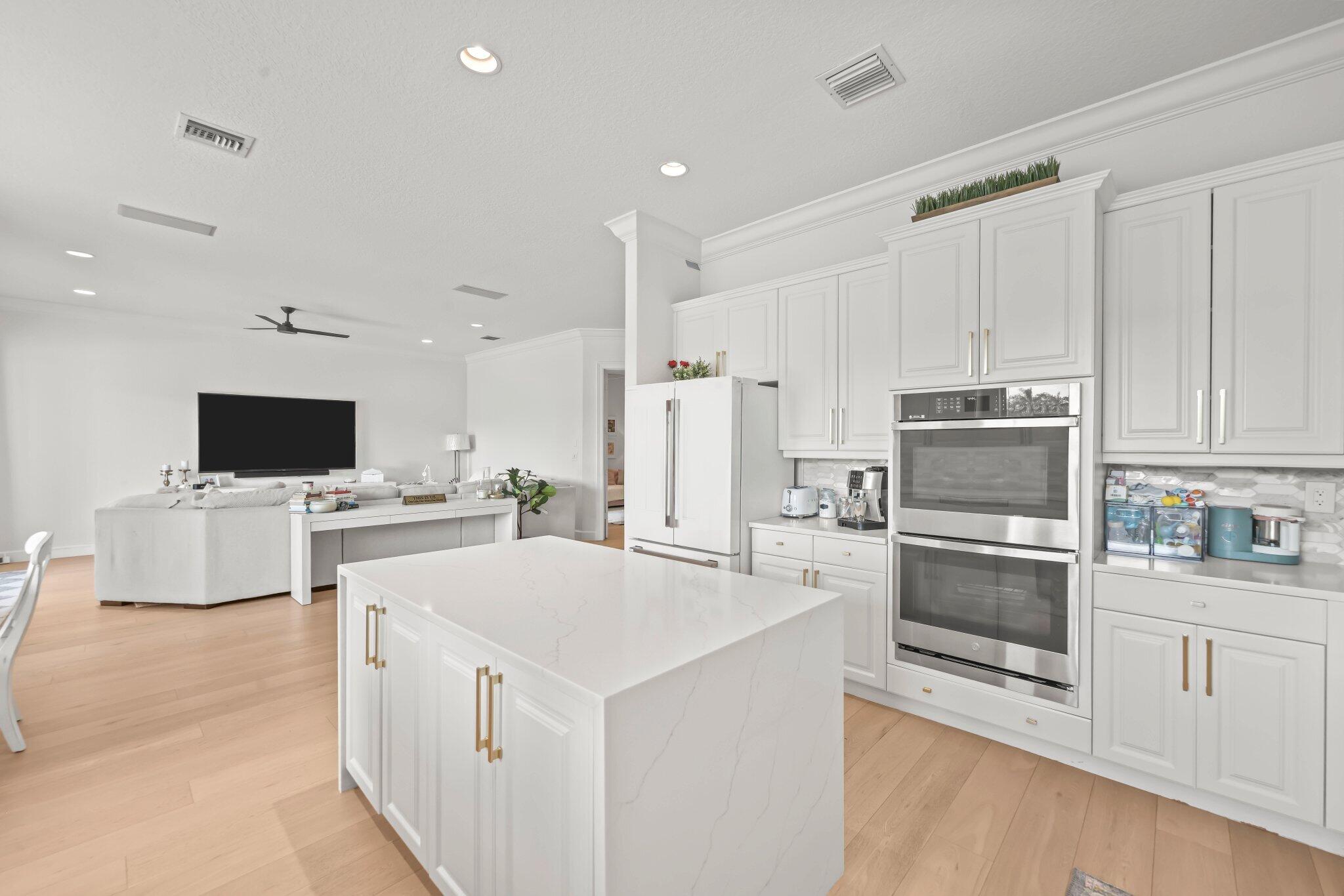 19650 Estuary Drive Boca Raton, FL 33498 - Photo 25 of 83 a kitchen with stainless steel appliances a stove top oven a sink a refrigerator and white cabinets