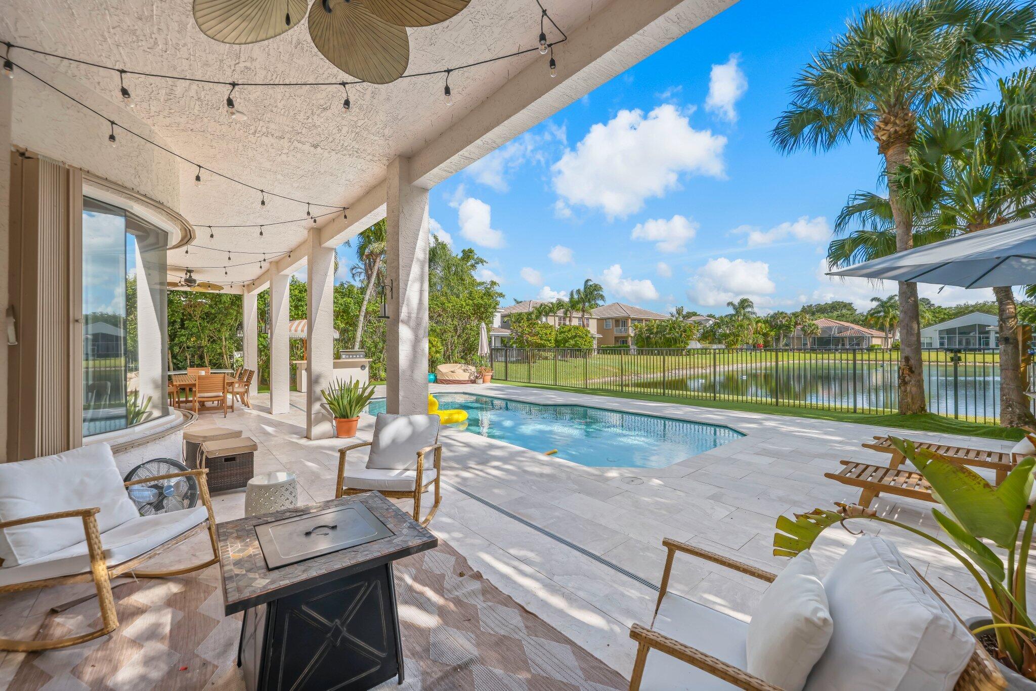 19650 Estuary Drive Boca Raton, FL 33498 - Photo 31 of 83 a view of swimming pool with outdoor seating and city view