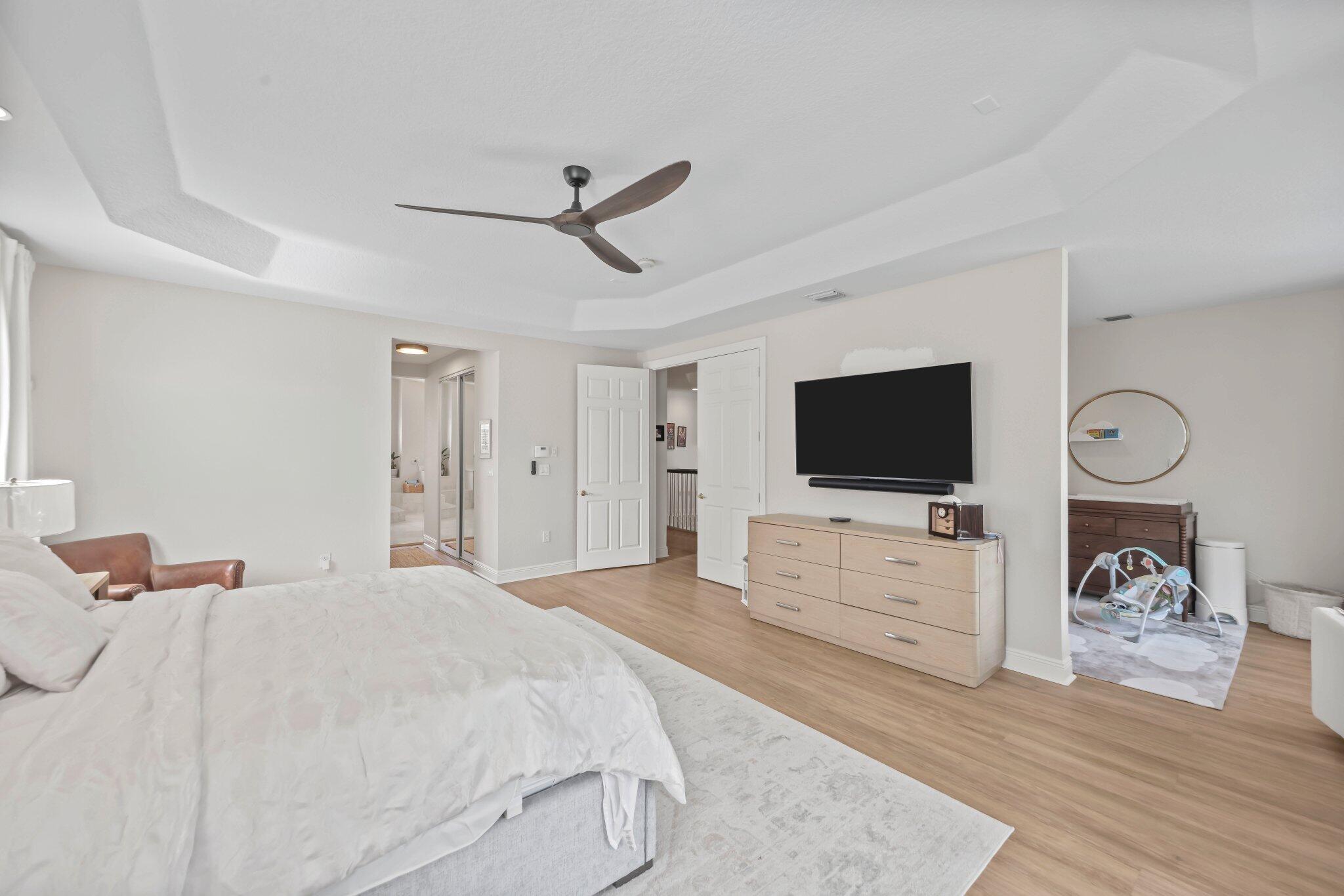 19650 Estuary Drive Boca Raton, FL 33498 - Photo 54 of 83 a bedroom with a bed and a flat screen tv