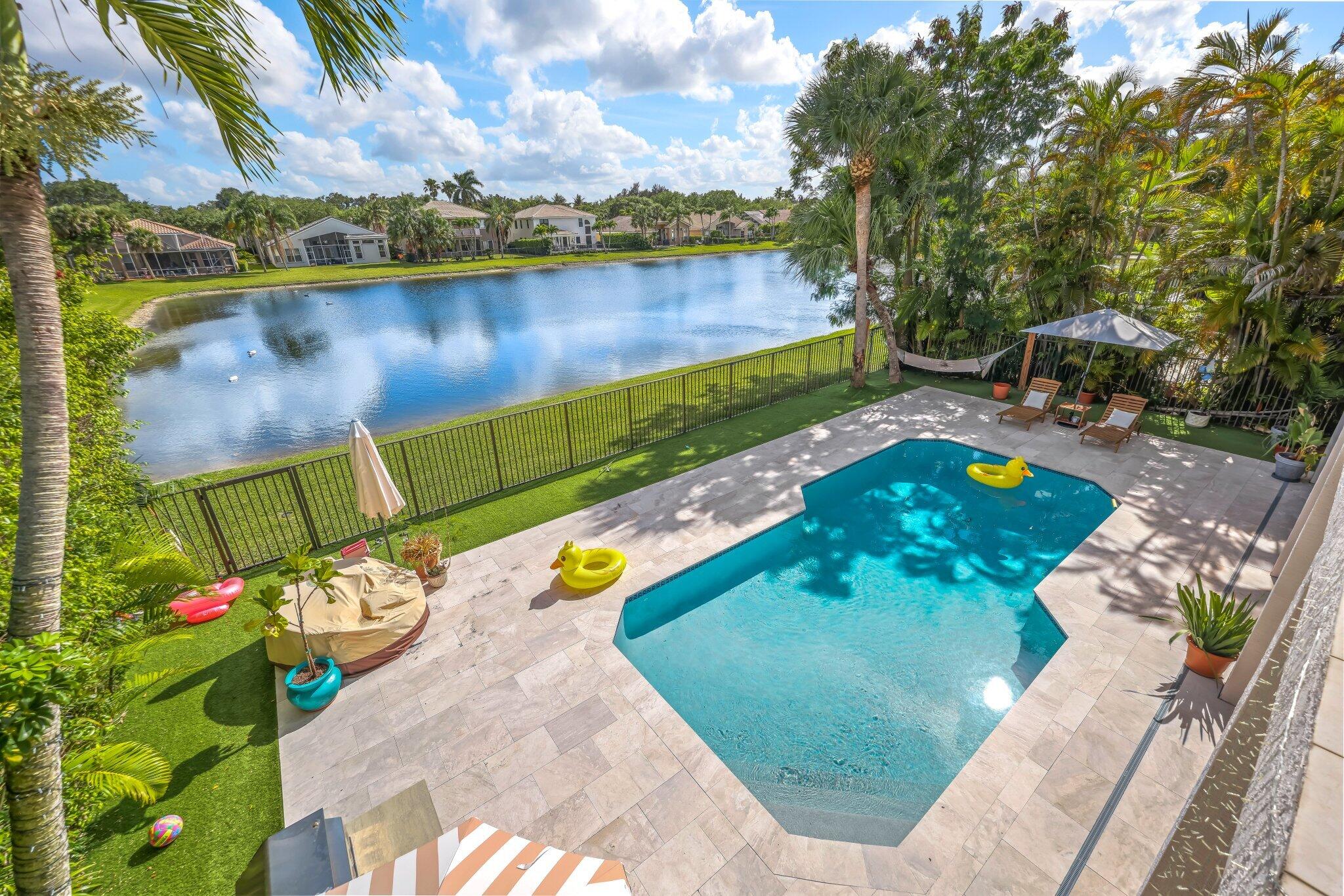 19650 Estuary Drive Boca Raton, FL 33498 - Photo 66 of 83 a view of a swimming pool with a patio