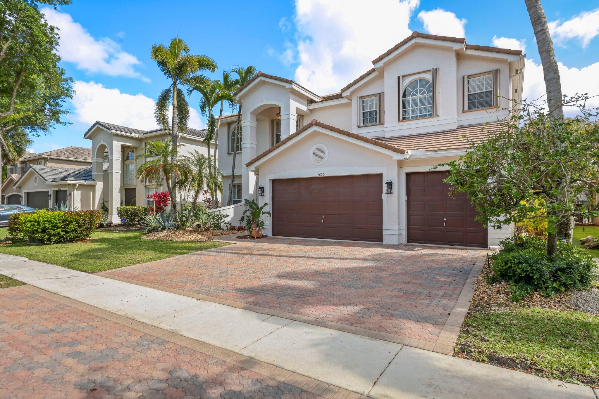 19650 Estuary Drive Boca Raton, FL 33498 - Photo 8 of 83 a front view of a house with a yard and garage