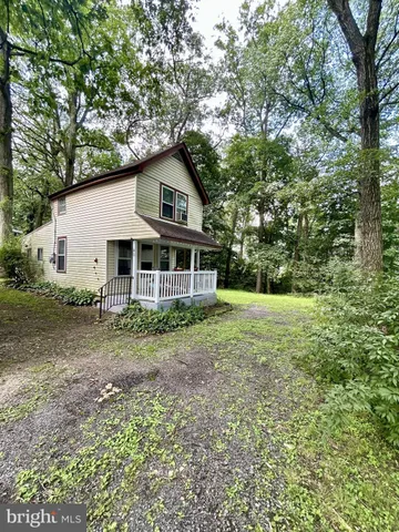 a view of a house with yard and sitting area
