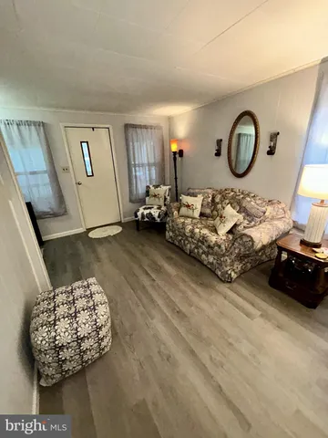 a living room with furniture and a large mirror