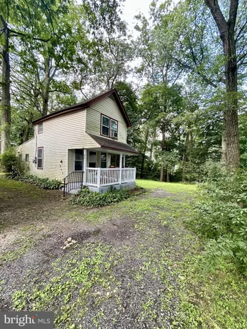 a view of a house with yard and sitting area