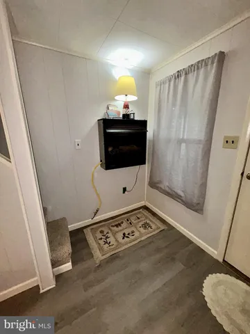 a living room with a fireplace furniture and a rug