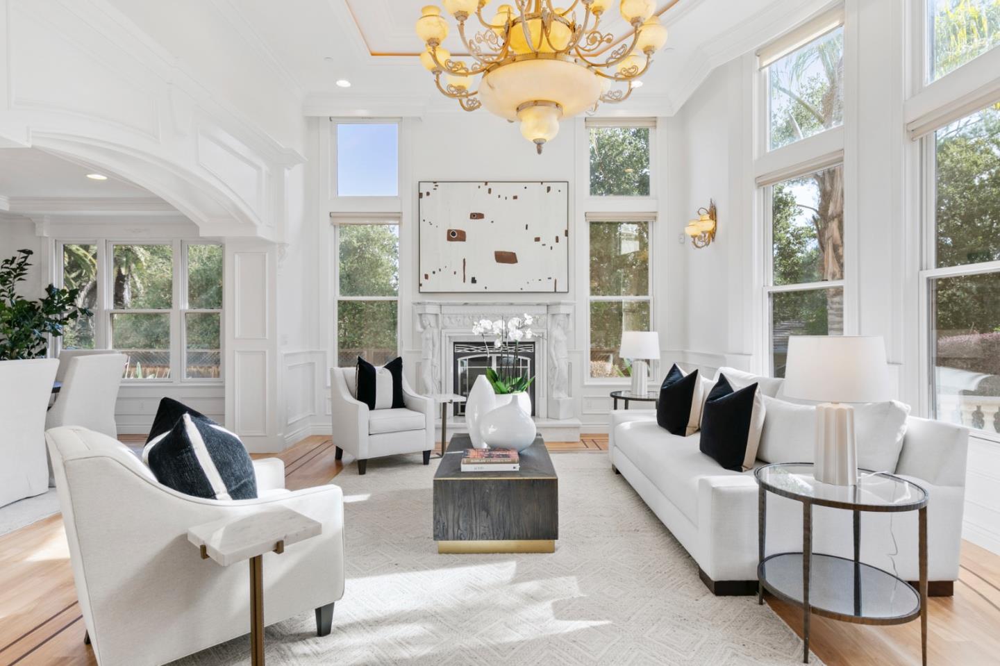 779 Mora Drive Los Altos, CA 94024 - Photo 10 of 81 a living room with furniture a chandelier and a large mirror