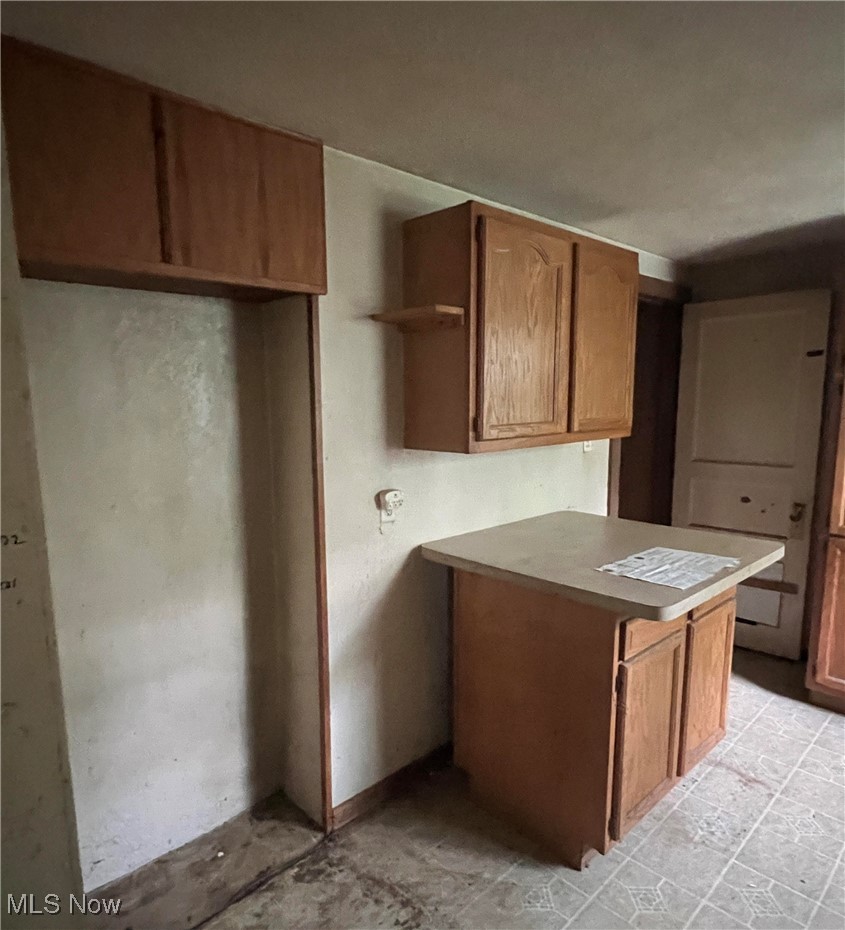 6411 River Road Madison, OH 44057 - Photo 5 of 8 Kitchen with kitchen peninsula and light tile patterned floors