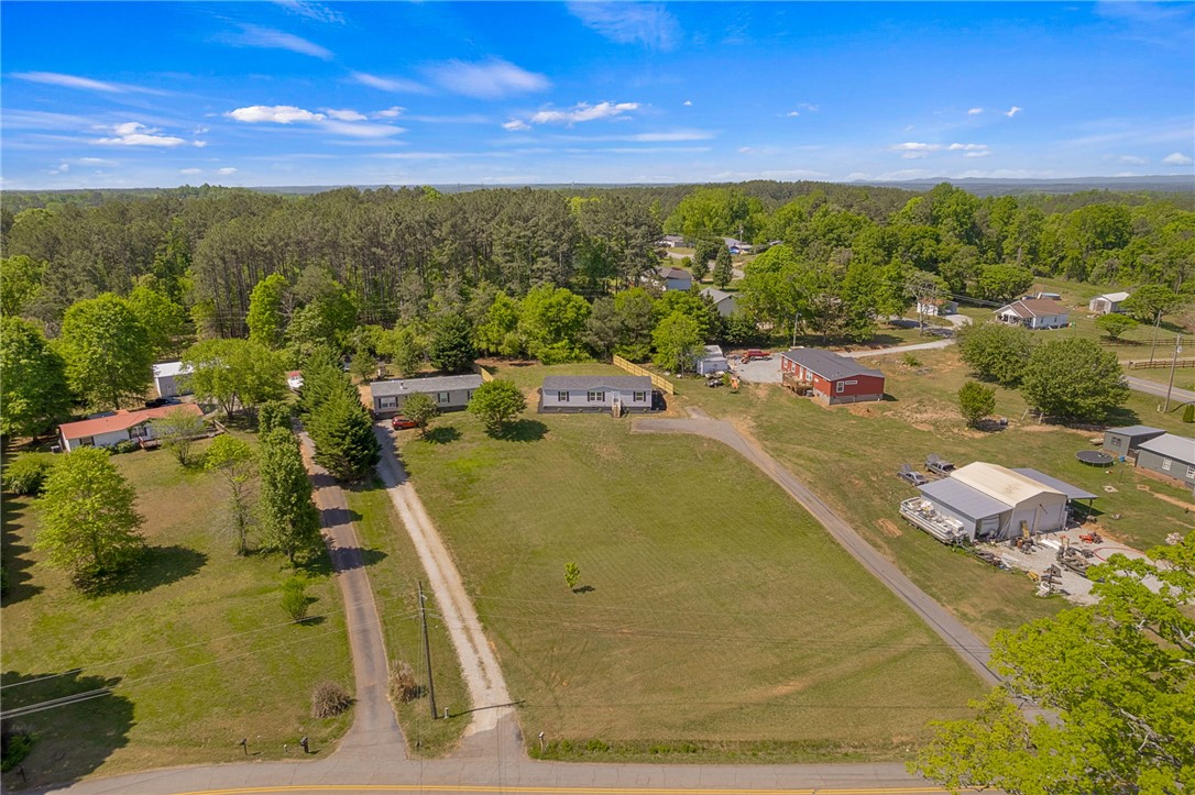 375 Griggs Road Six Mile, SC 29682 - Photo 32 of 36 This aerial view showcases a residential landscape with abundant greenery and expansive open spaces.