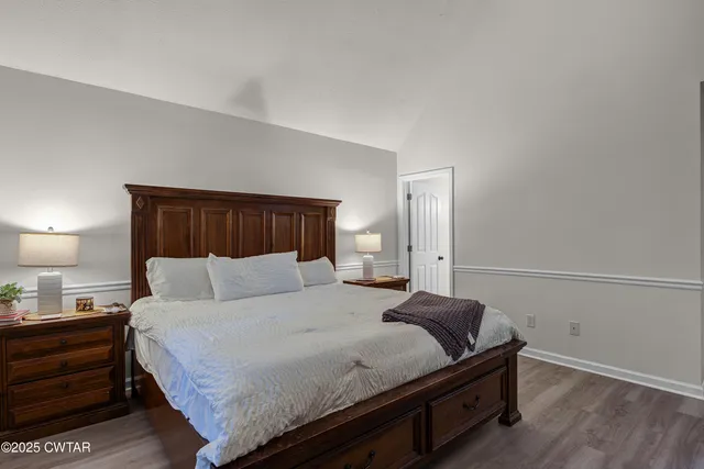 a bedroom with a bed and a night stand