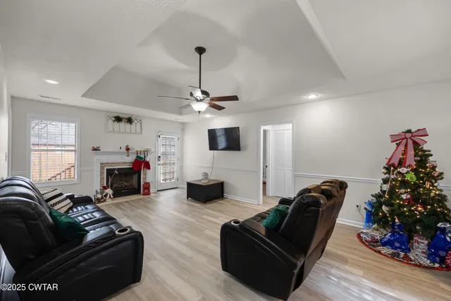 a living room with furniture a fireplace and a flat screen tv