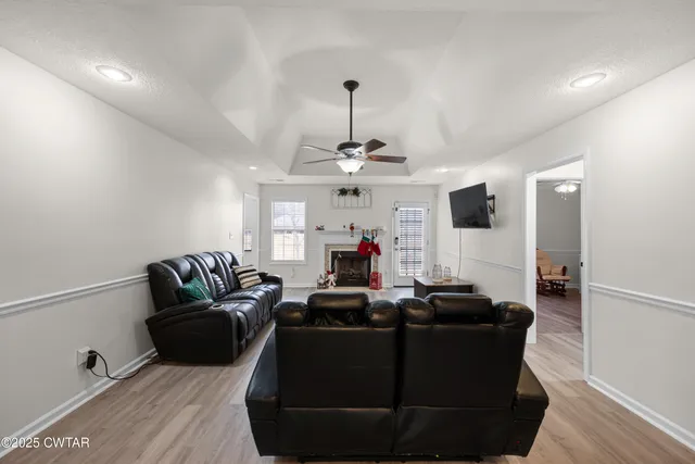 a living room with furniture and a chandelier